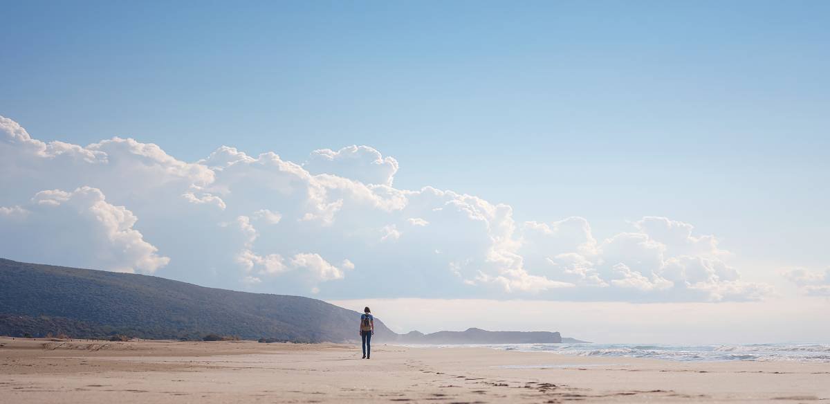 Lonely person walking on a beach